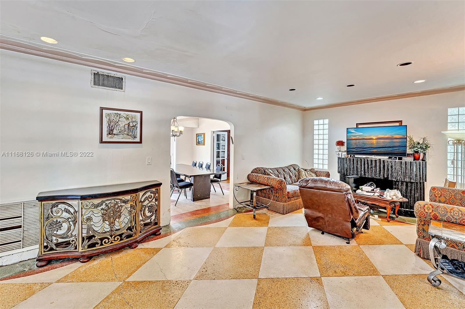 2033 North Bay Road Miami Beach, FL 33140 - Photo 6 of 38 a living room with furniture a rug and a flat screen tv