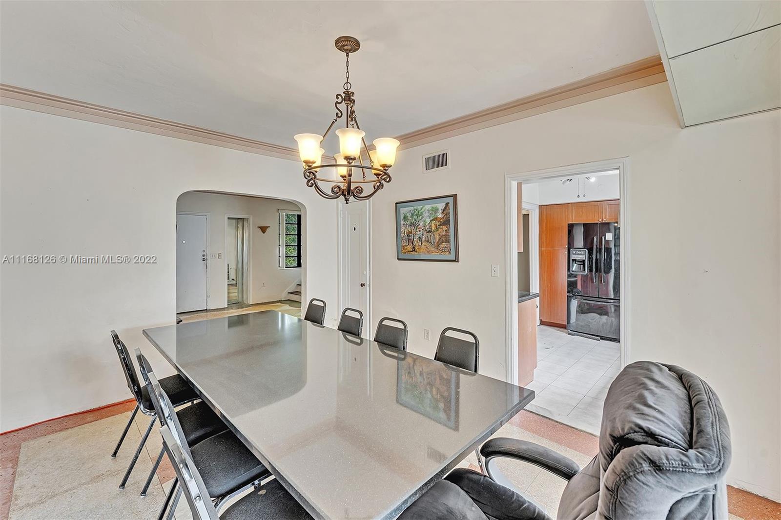 2033 North Bay Road Miami Beach, FL 33140 - Photo 8 of 38 a view of a dining room with furniture wooden floor and chandelier