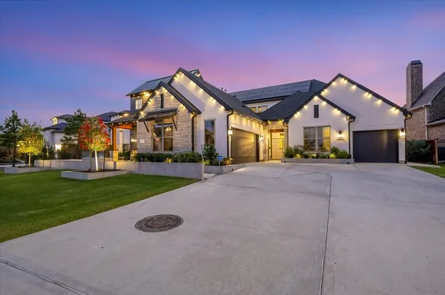 a view of a house with a yard and plants