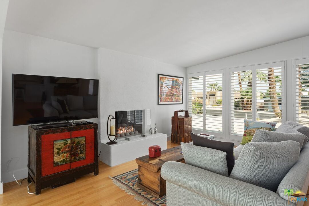 73501 Silver Moon Trail Palm Desert, CA 92260 - Photo 12 of 38 a living room with furniture a flat screen tv and a fireplace