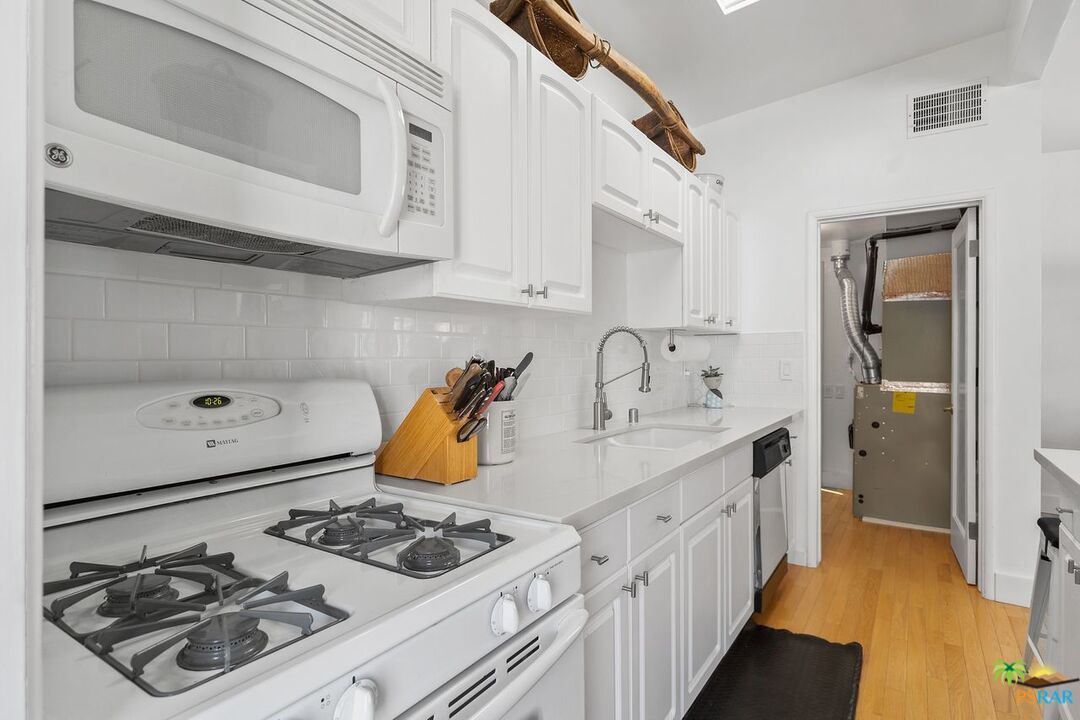 73501 Silver Moon Trail Palm Desert, CA 92260 - Photo 16 of 38 a kitchen with a sink stove and cabinets