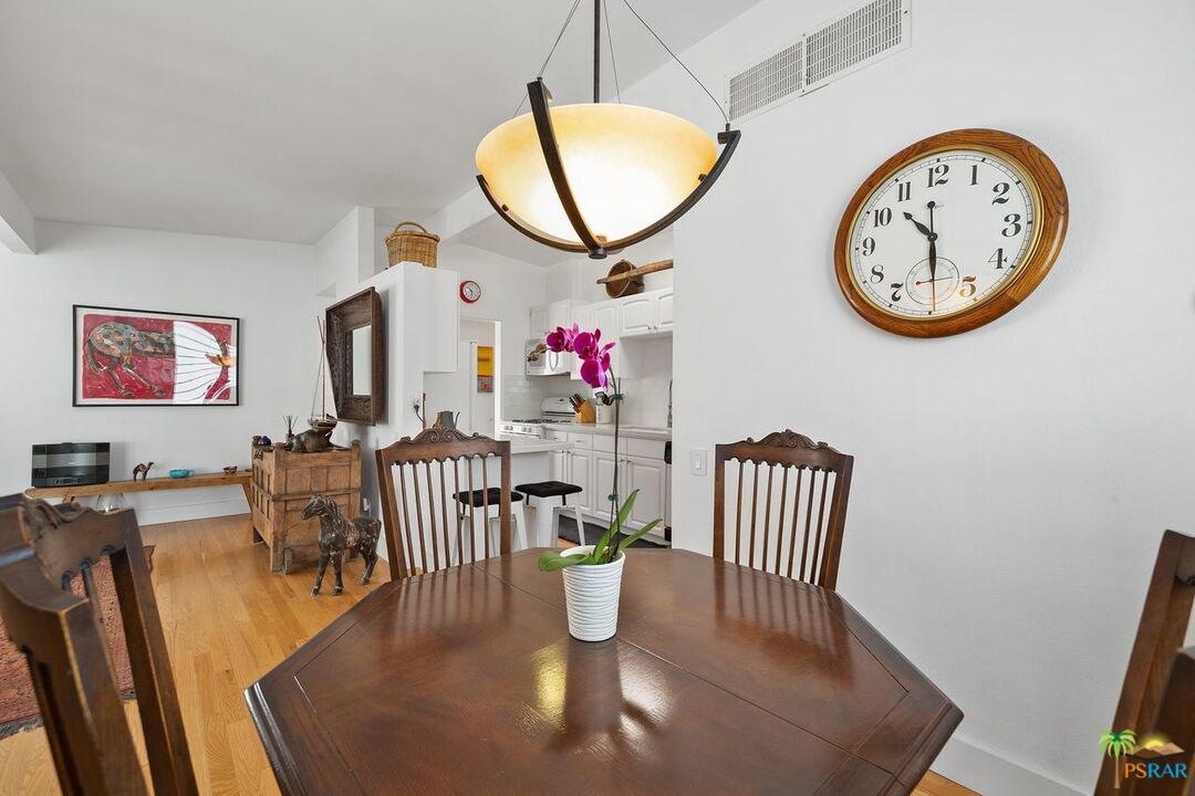 73501 Silver Moon Trail Palm Desert, CA 92260 - Photo 19 of 38 a view of a dining room with furniture a potted plant and wooden floor