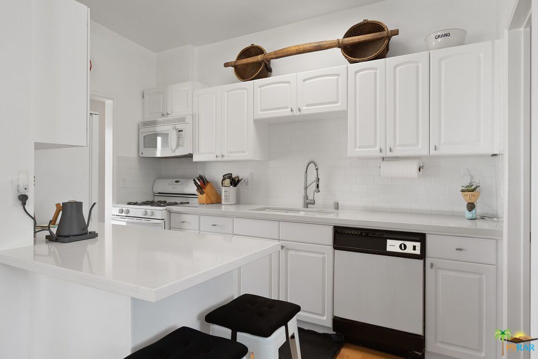 73501 Silver Moon Trail Palm Desert, CA 92260 - Photo 20 of 38 a kitchen with a sink cabinets and wooden floor