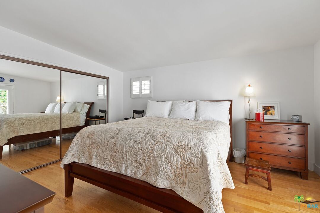 73501 Silver Moon Trail Palm Desert, CA 92260 - Photo 22 of 38 a bedroom with a bed and large mirror