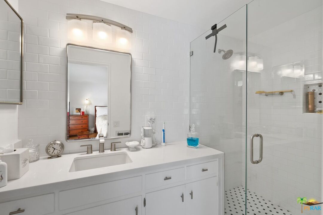 73501 Silver Moon Trail Palm Desert, CA 92260 - Photo 24 of 38 a bathroom with a double vanity sink mirror and shower