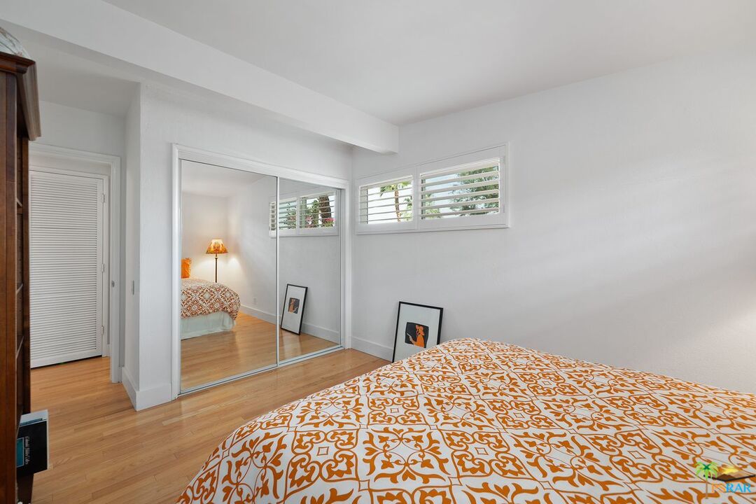 73501 Silver Moon Trail Palm Desert, CA 92260 - Photo 26 of 38 a bedroom with a bed and wooden floor