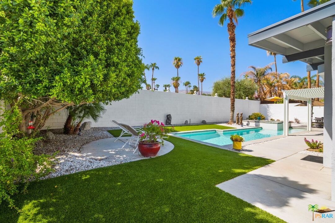 73501 Silver Moon Trail Palm Desert, CA 92260 - Photo 29 of 38 a view of a swimming pool with an outdoor space and seating area