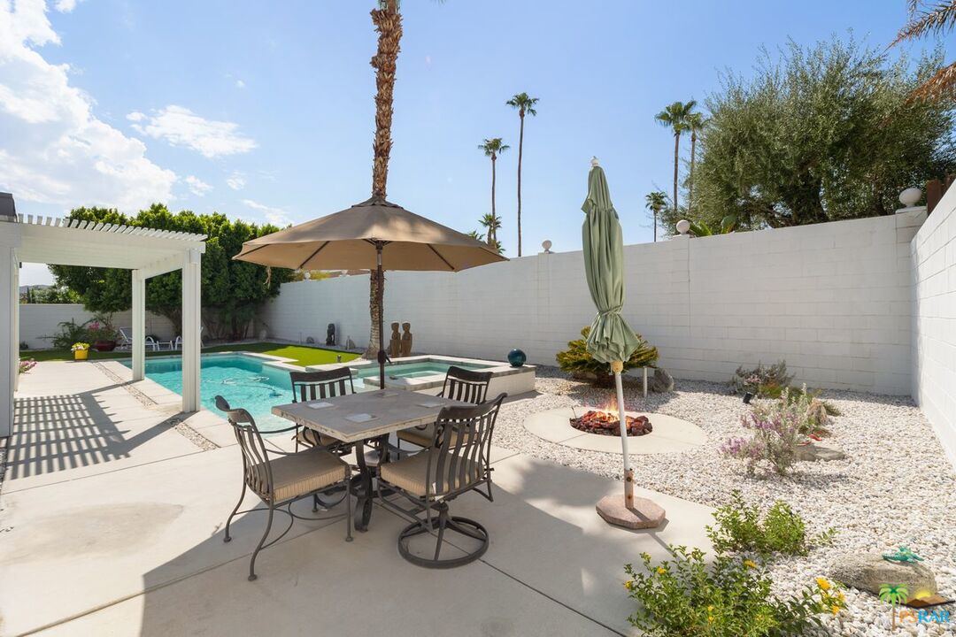 73501 Silver Moon Trail Palm Desert, CA 92260 - Photo 34 of 38 a view of a patio with a table and chairs under an umbrella