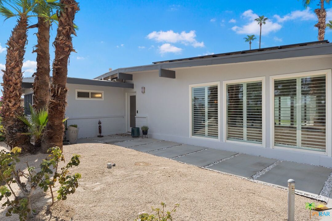 73501 Silver Moon Trail Palm Desert, CA 92260 - Photo 4 of 38 a front view of a house with a yard and garage