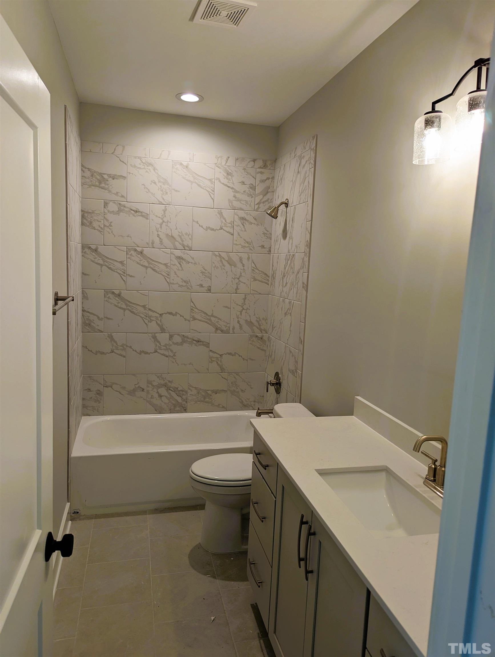 200 East Moore Street Apex, NC 27502 - Photo 11 of 19 a bathroom with a sink a toilet and shower