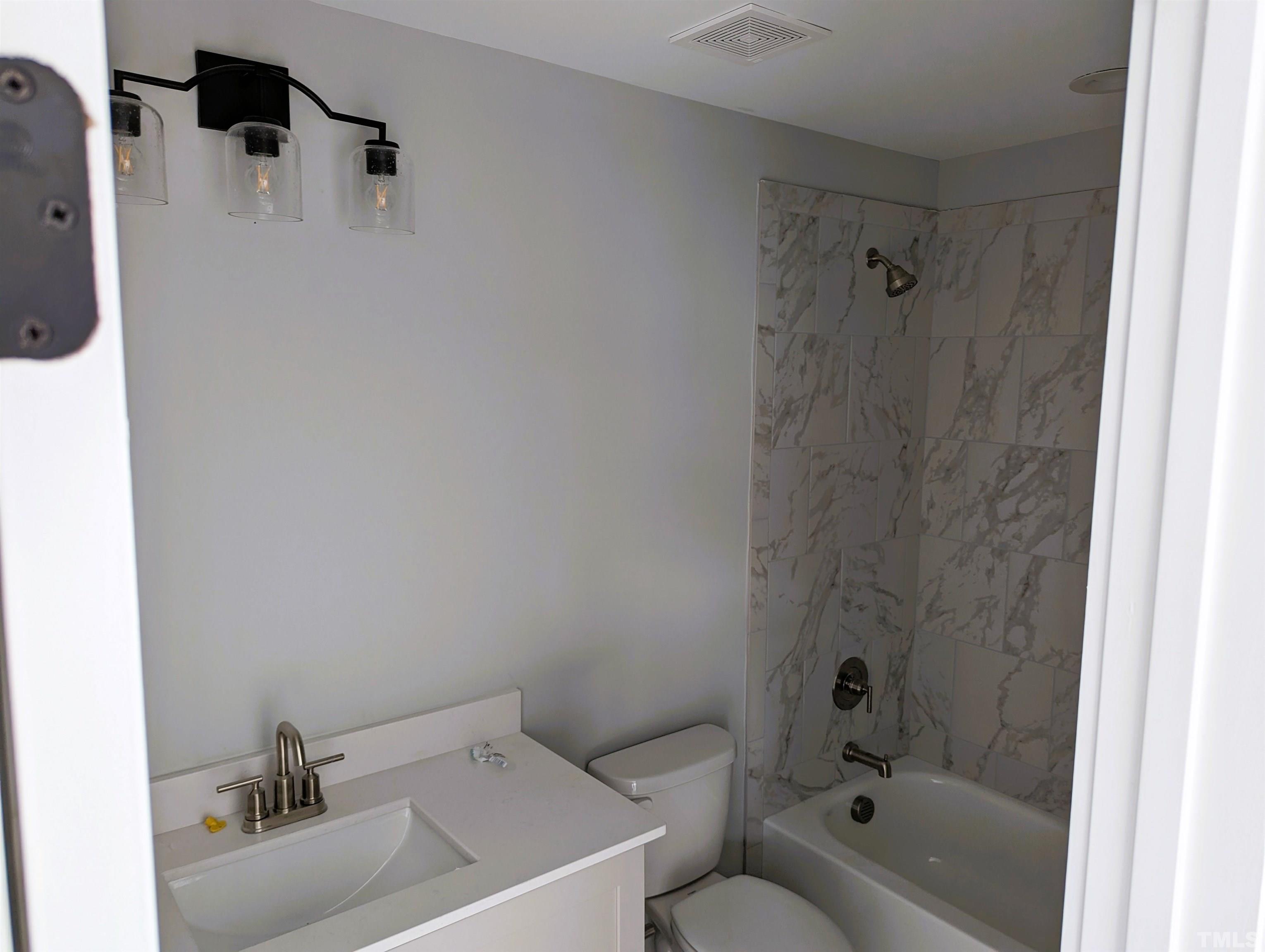 200 East Moore Street Apex, NC 27502 - Photo 13 of 19 a bathroom with a sink and a shower