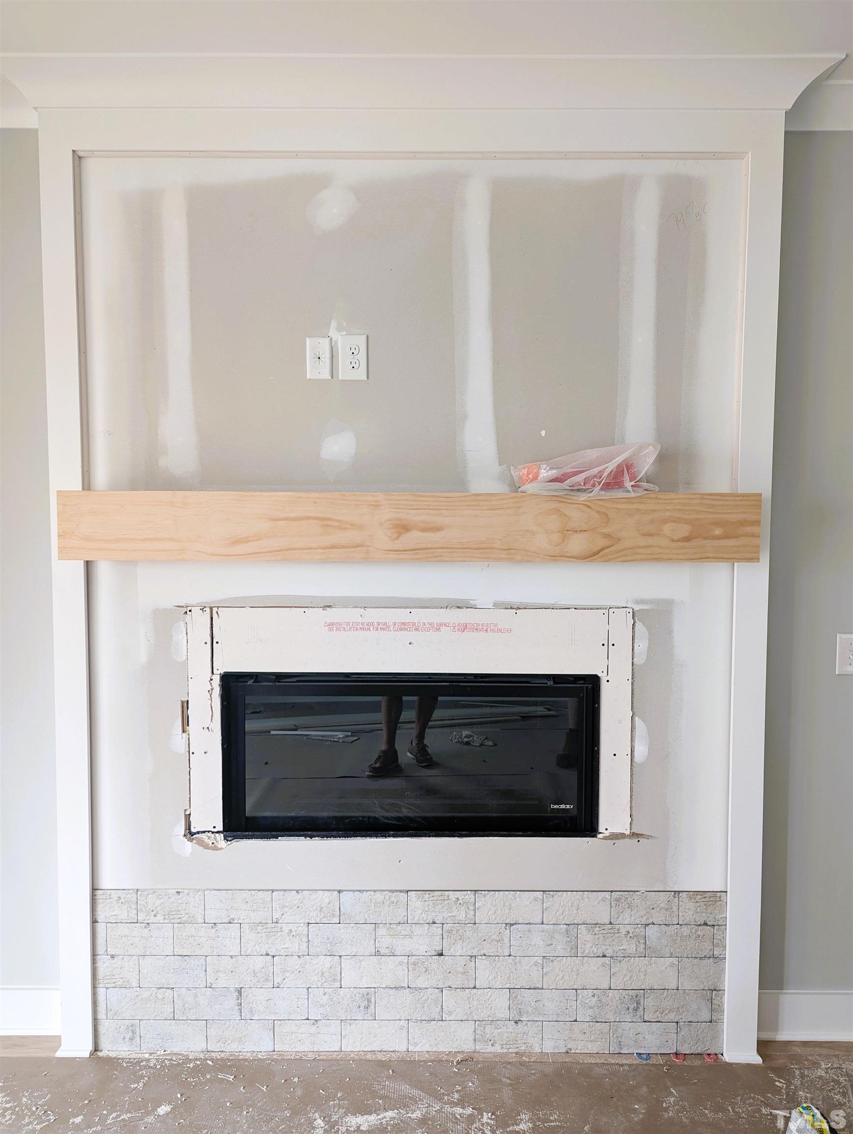 200 East Moore Street Apex, NC 27502 - Photo 3 of 19 a fireplace with white wall