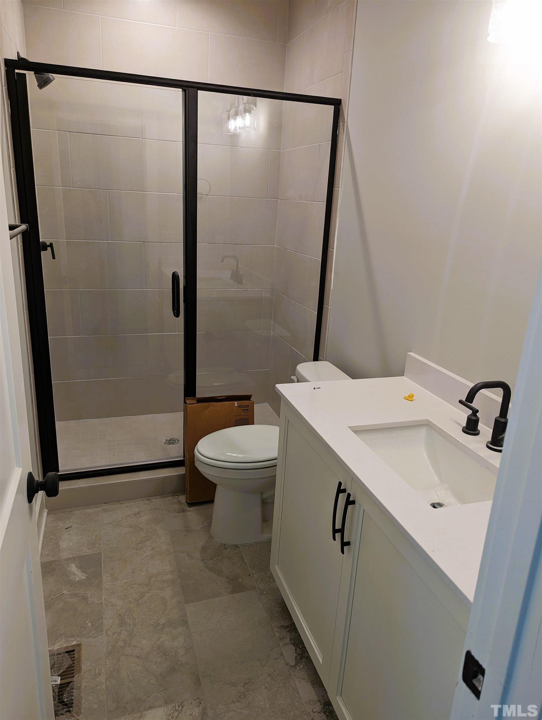 200 East Moore Street Apex, NC 27502 - Photo 5 of 19 a bathroom with a sink a mirror and a toilet