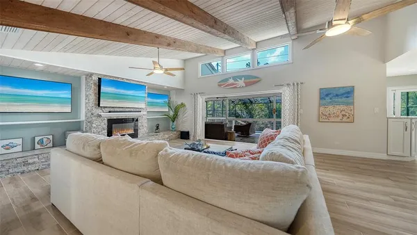 a kitchen with stainless steel appliances kitchen island wooden floors and white cabinets