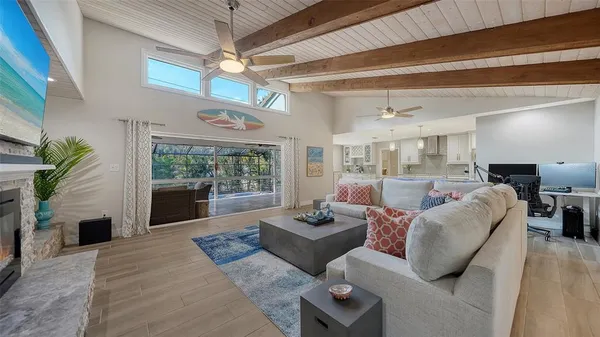a living room with furniture a fireplace and a table