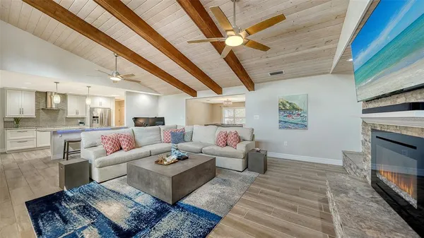 a living room with furniture large window and a fireplace