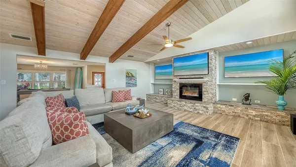 a large kitchen with granite countertop a large counter top appliances and cabinets