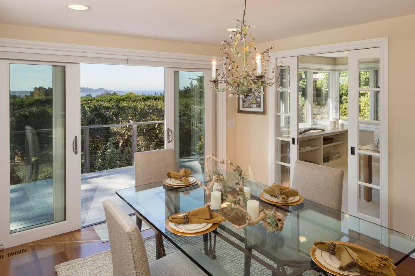 25840 Hatton Road Carmel, CA 93923 - Photo 14 of 43 a view of a dining room with furniture wooden floor and chandelier