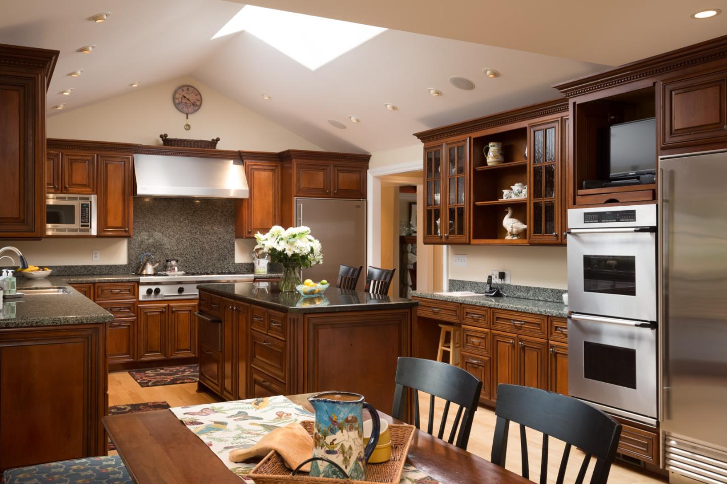 25840 Hatton Road Carmel, CA 93923 - Photo 16 of 43 a kitchen with stainless steel appliances granite countertop a sink stove and refrigerator