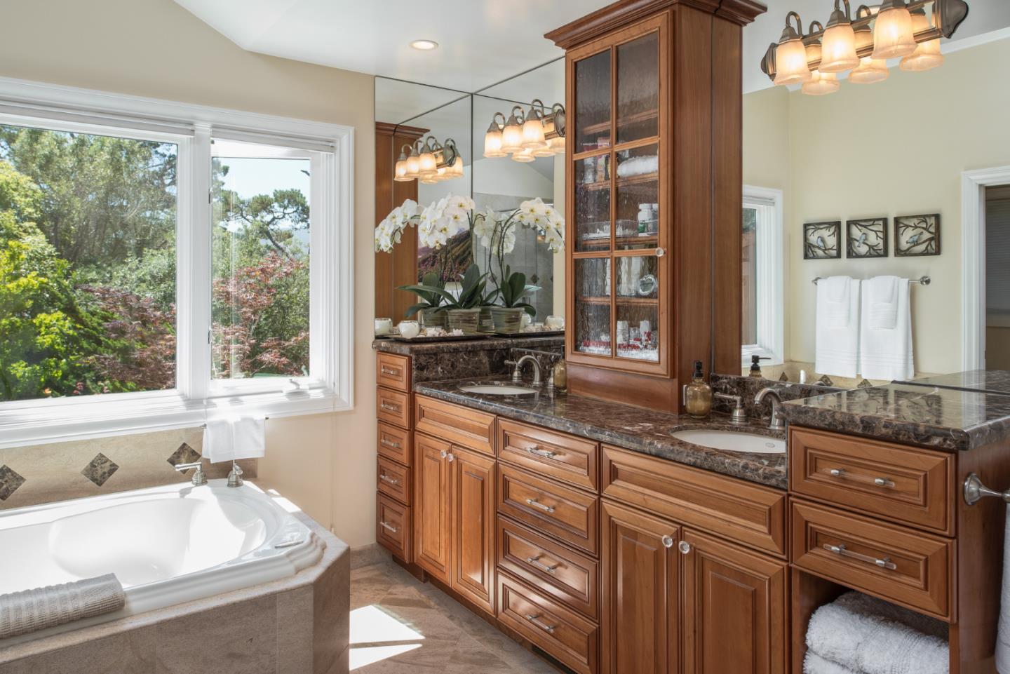 25840 Hatton Road Carmel, CA 93923 - Photo 28 of 43 a bathroom with a granite countertop tub sink and mirror