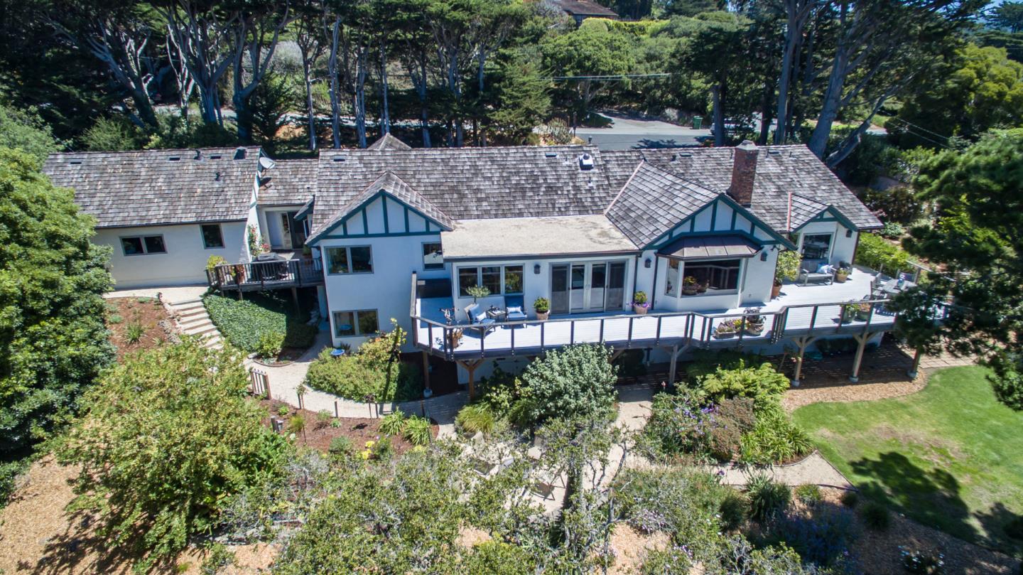 25840 Hatton Road Carmel, CA 93923 - Photo 42 of 43 a front view of a house with a yard and potted plants