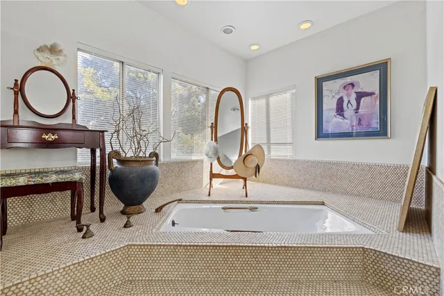 a view of a hallway with wooden floor and windows