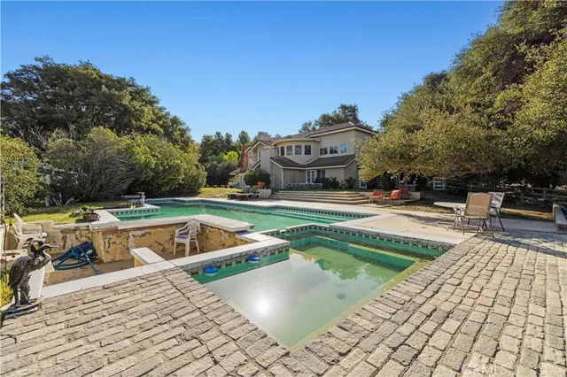 a view of outdoor space with swimming pool and seating