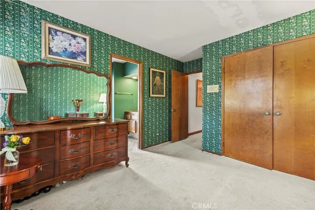 a view of a dining room with furniture a chandelier and large windows
