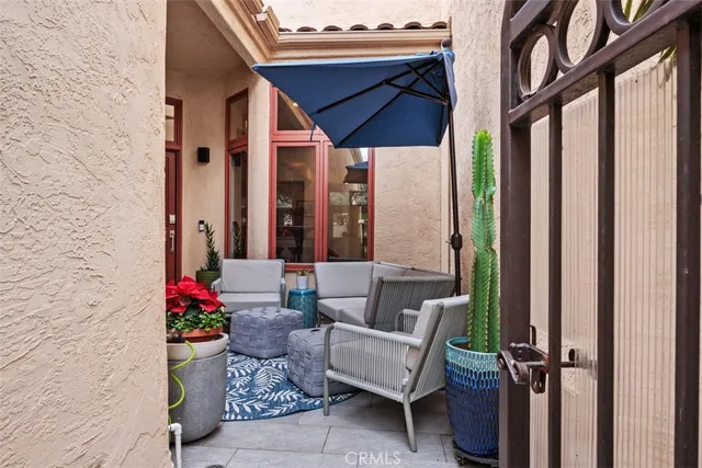 a view of a patio with couches and potted plants