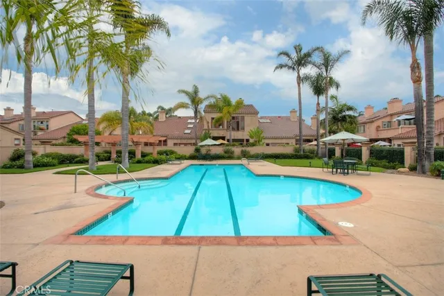 a view of a backyard with swimming pool