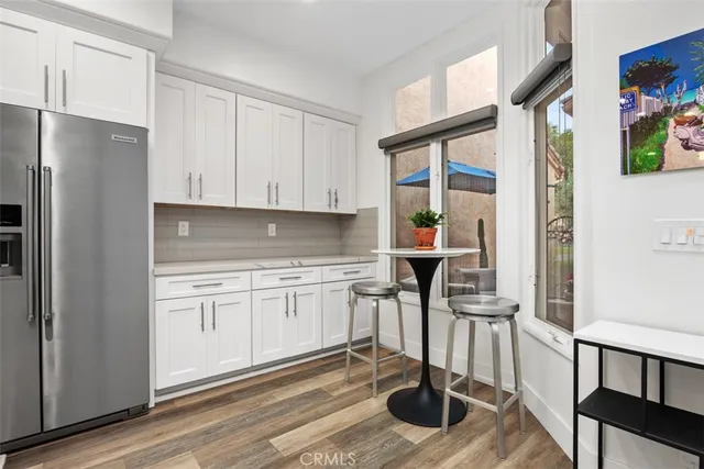 a kitchen with sink refrigerator and cabinets