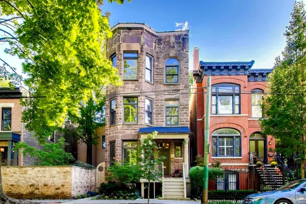 a bunch of flowers are in front of a house