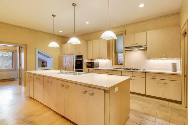 a living room with a fireplace and a large window
