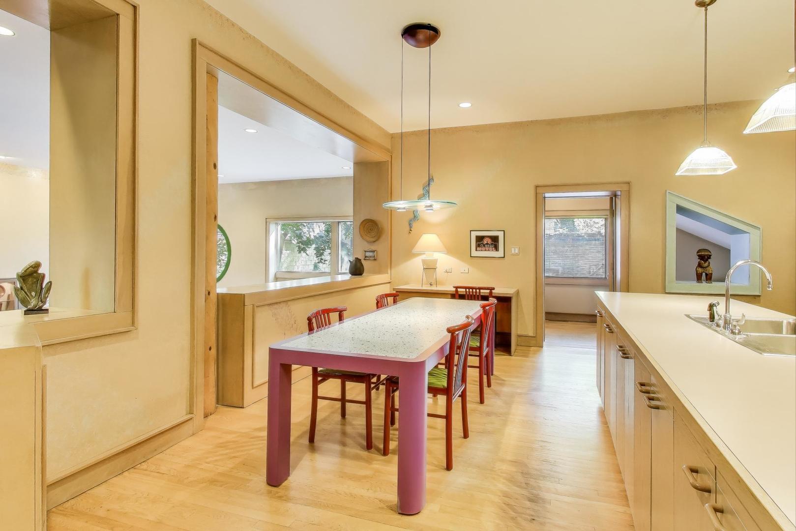 907-909 West Webster Avenue Chicago, IL 60614 - Photo 17 of 71 a dining room with stainless steel appliances kitchen island granite countertop a table chairs and a refrigerator