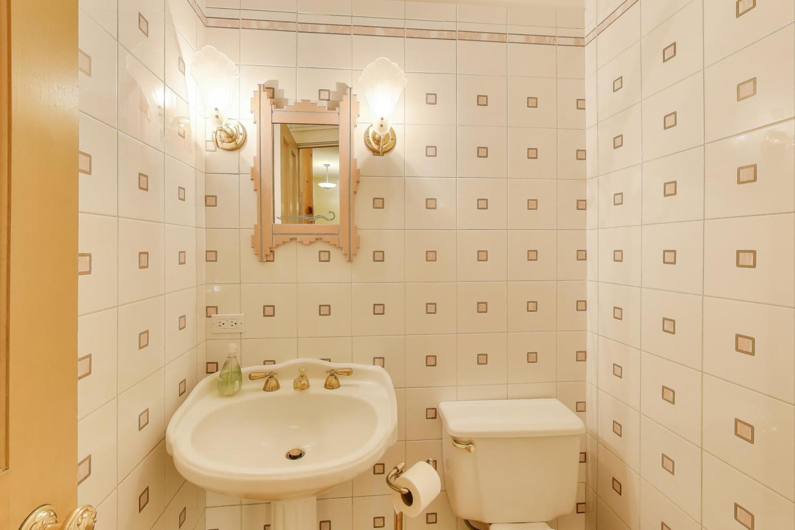 907-909 West Webster Avenue Chicago, IL 60614 - Photo 25 of 71 a bathroom with a sink a toilet and shower curtain