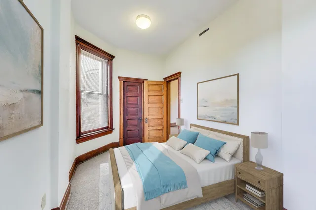 a view of an empty room with furniture and storage