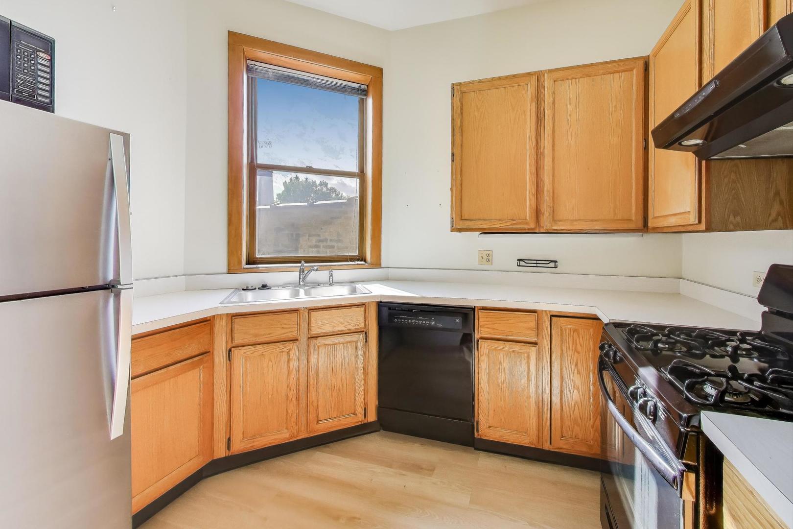 907-909 West Webster Avenue Chicago, IL 60614 - Photo 47 of 71 a kitchen with stainless steel appliances granite countertop a sink stove and refrigerator