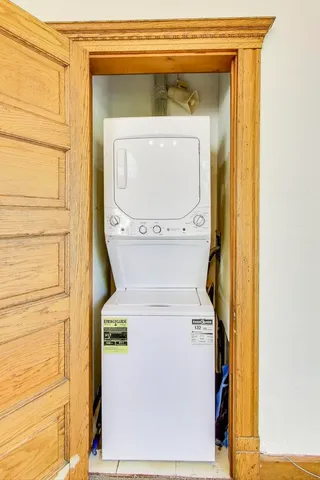a picture of a room that has a window and a potted plant