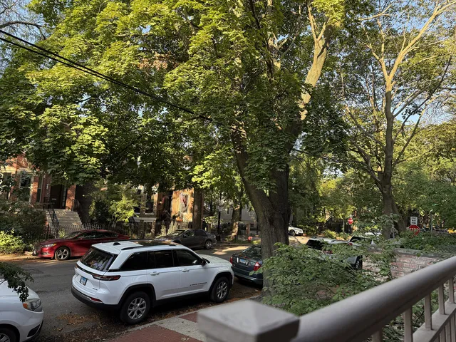 a living room with furniture a clock and a large window