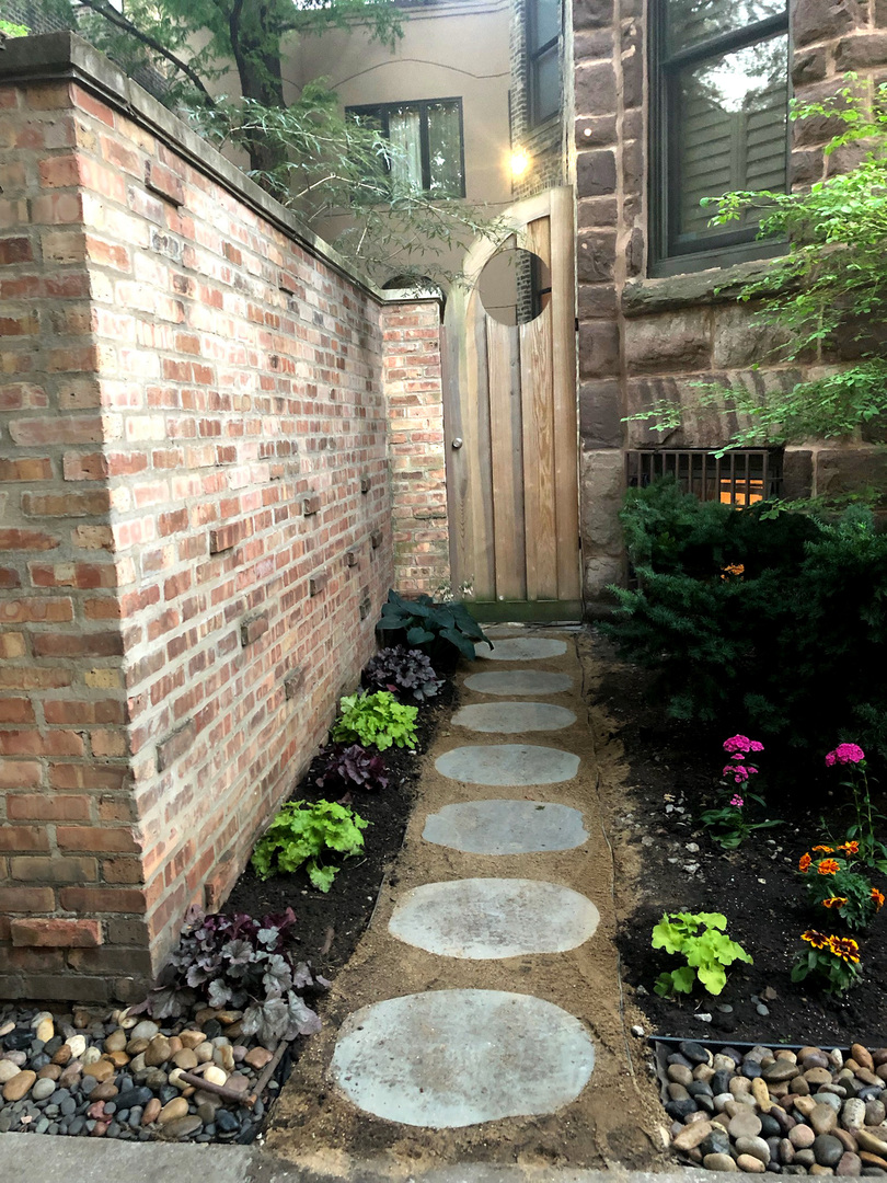907-909 West Webster Avenue Chicago, IL 60614 - Photo 6 of 71 a front view of a house with a yard and flowers