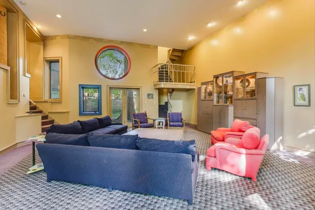 a large kitchen with kitchen island a island a sink a stove and a chandelier