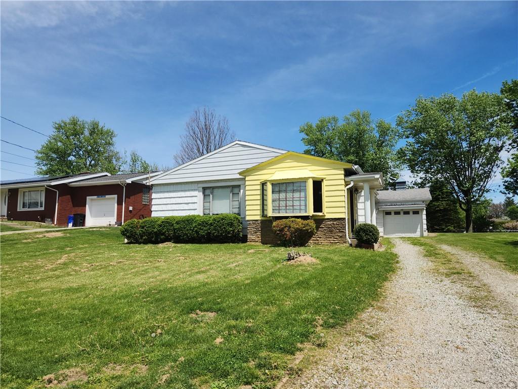 122 Taylor Run Road Monongahela, PA 15063 - Photo 1 of 34 a front view of a house with a yard and garage
