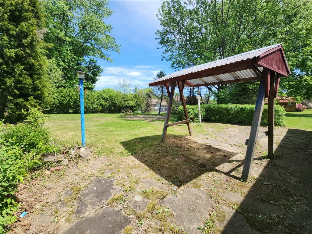 122 Taylor Run Road Monongahela, PA 15063 - Photo 33 of 34 a view of a backyard with a slide trees and wooden fence