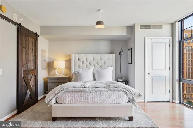 a bedroom with a large bed and a chandelier