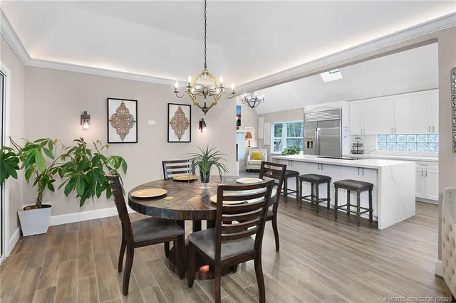 a living room with furniture large window and wooden floor