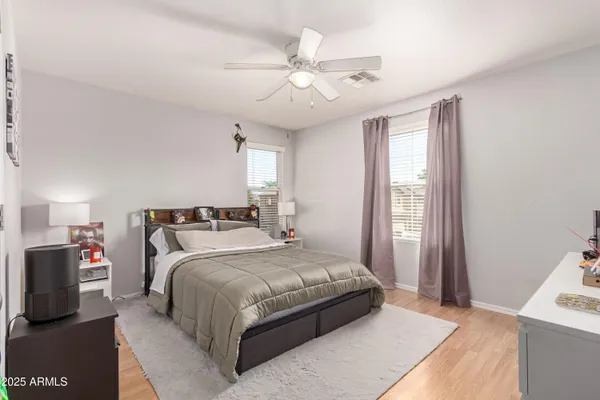 a bedroom with a large bed and a window