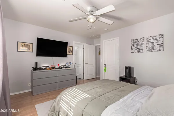 a bedroom with a bed and a flat screen tv