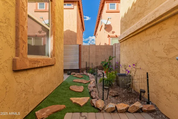 a backyard of a house with lots of green space and plants