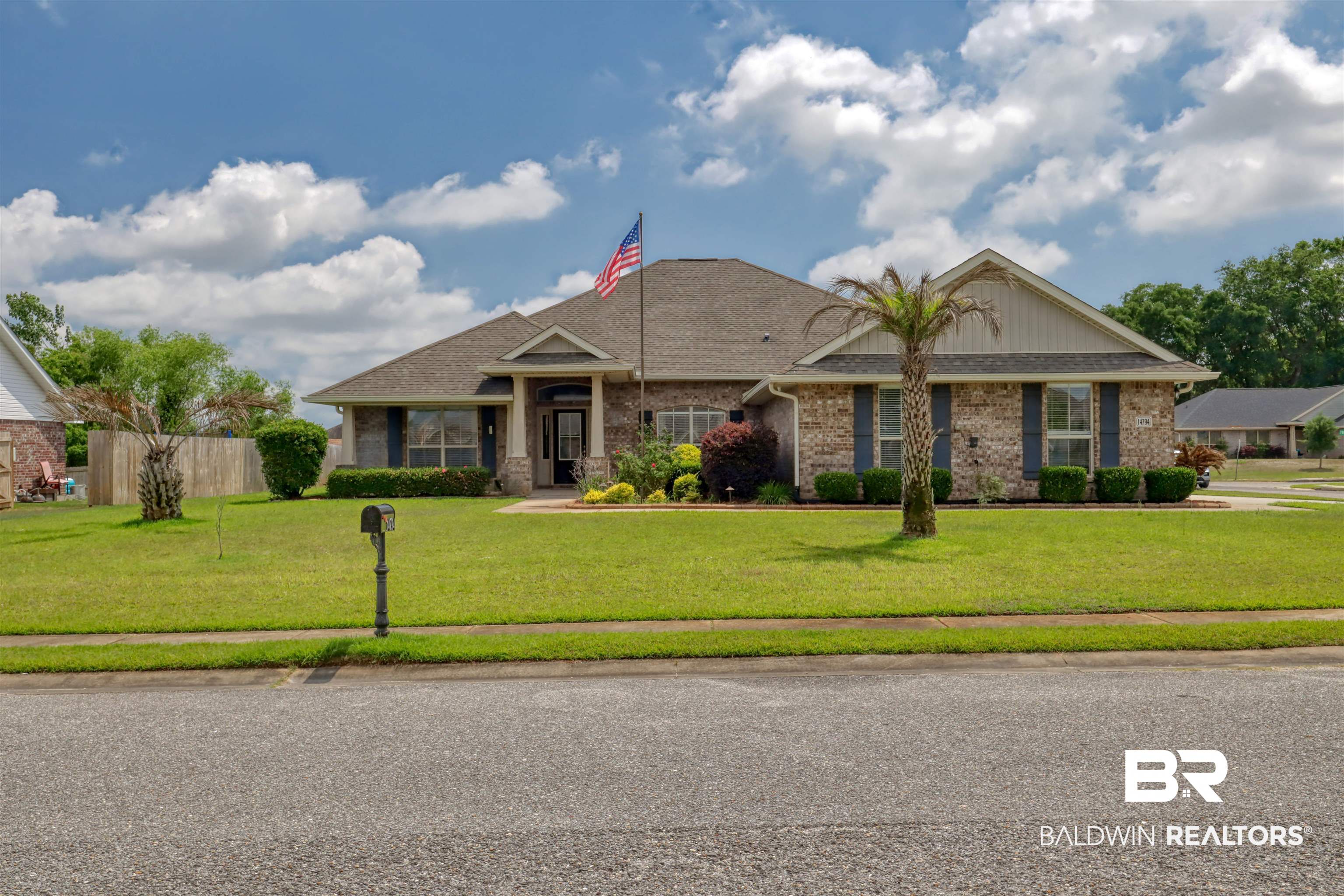 14794 Troon Drive Foley, AL 36535 - Photo 1 of 33 View of front of house with brick siding, a shingled roof, fence, and a front yard