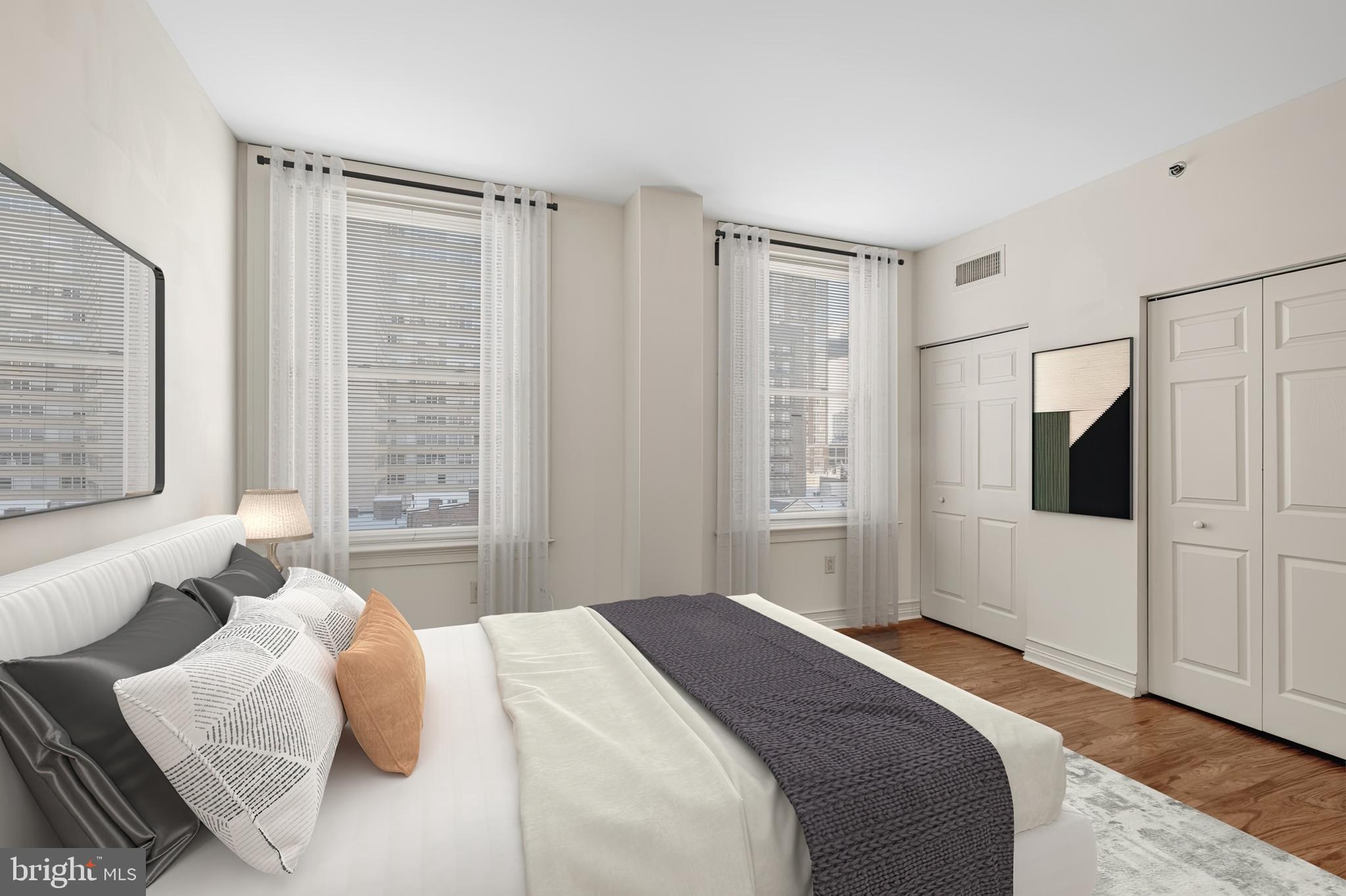 204 South 17th Street, Unit 5H Philadelphia, PA 19103 - Photo 3 of 15 a bedroom with a bed and a flat screen tv